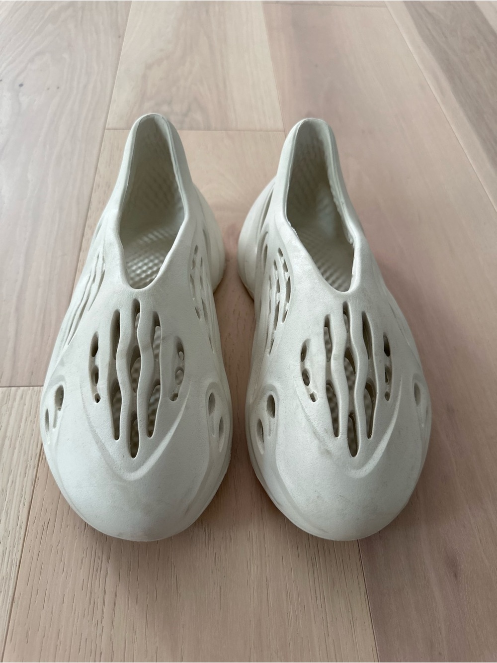 adidas Yeezy slip ons in Off-White/Cream